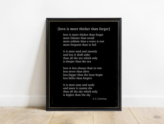 EE Cummings Love Is More Thicker Than Forget poem print in a black frame, black background