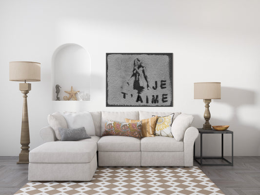 Je t'aime Paris street art photograph of a stencil girl on a grey wall, black and white, shown framed in a living room