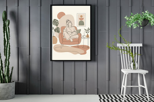 Woman reading in an armchair with a cup of tea, line art print framed in a room with plants
