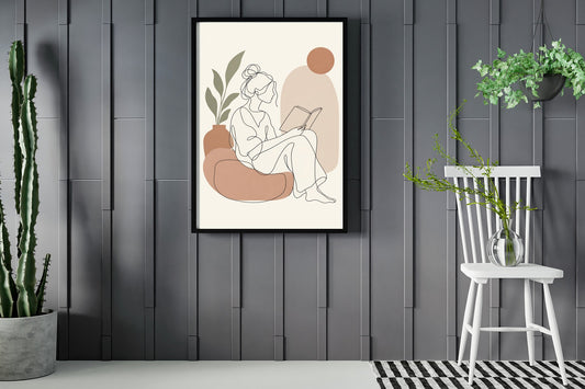 Woman reading a book, seen in profile, line art print framed in a room with plants