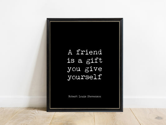 Robert Louis Stevenson a friend is a gift you give yourself typewriter print in a black frame, black background