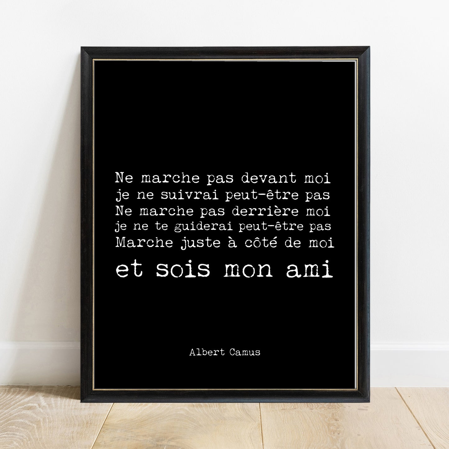 Albert Camus sois mon ami French quote print in a black frame, black background