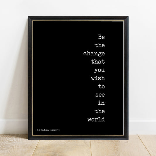 Be the change Mahatma Gandhi quote print in a black frame, black background