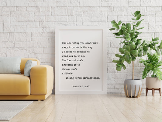 May include: A white framed print with a black and white quote by Viktor E. Frankl that reads 'The one thing you can't take away from me is the way I choose to respond to what you do to me. The last of one's freedoms is to choose one's attitude in any given circumstance. Viktor E. Frankl' The print is hanging on a white brick wall. A yellow couch is in the foreground. A green plant in a gray pot with a brown stand is on the right side of the image.