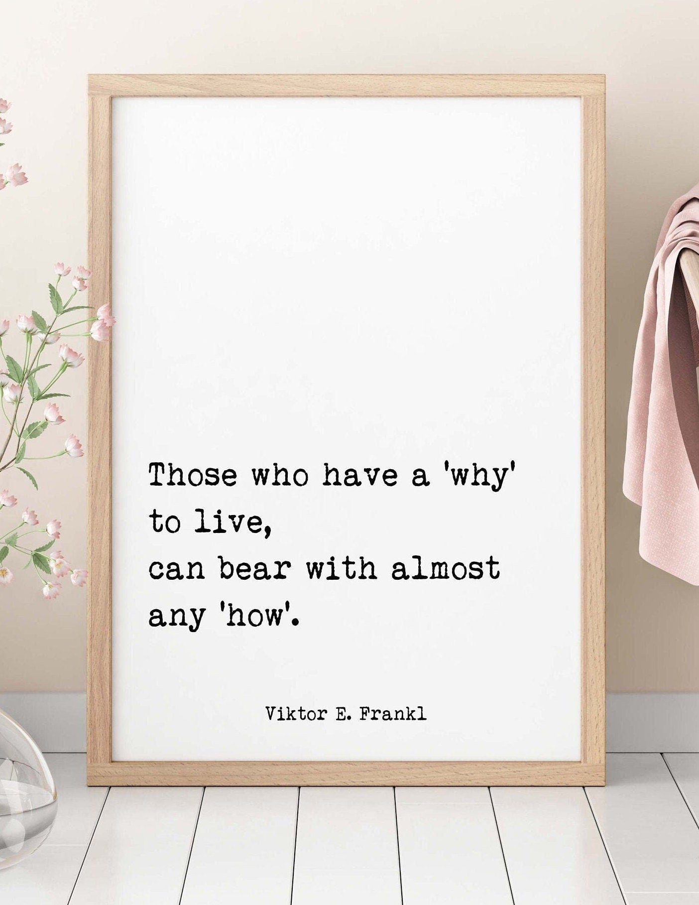 May include: A framed print with a white background and black text. The text reads 'Those who have a 'why' to live, can bear with almost any 'how'.' The text is attributed to Viktor E. Frankl.