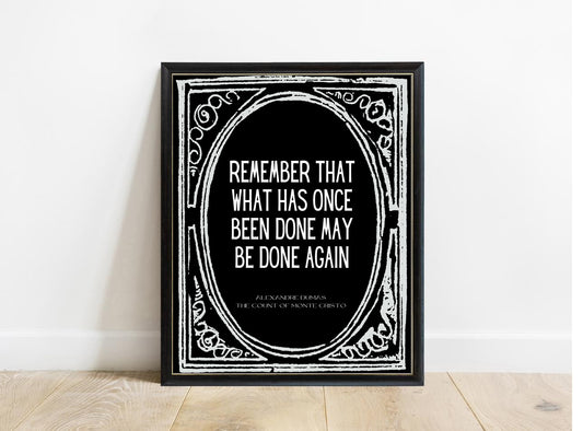 Alexandre Dumas Remember That What Has Once Been Done quote print in a black frame, black background