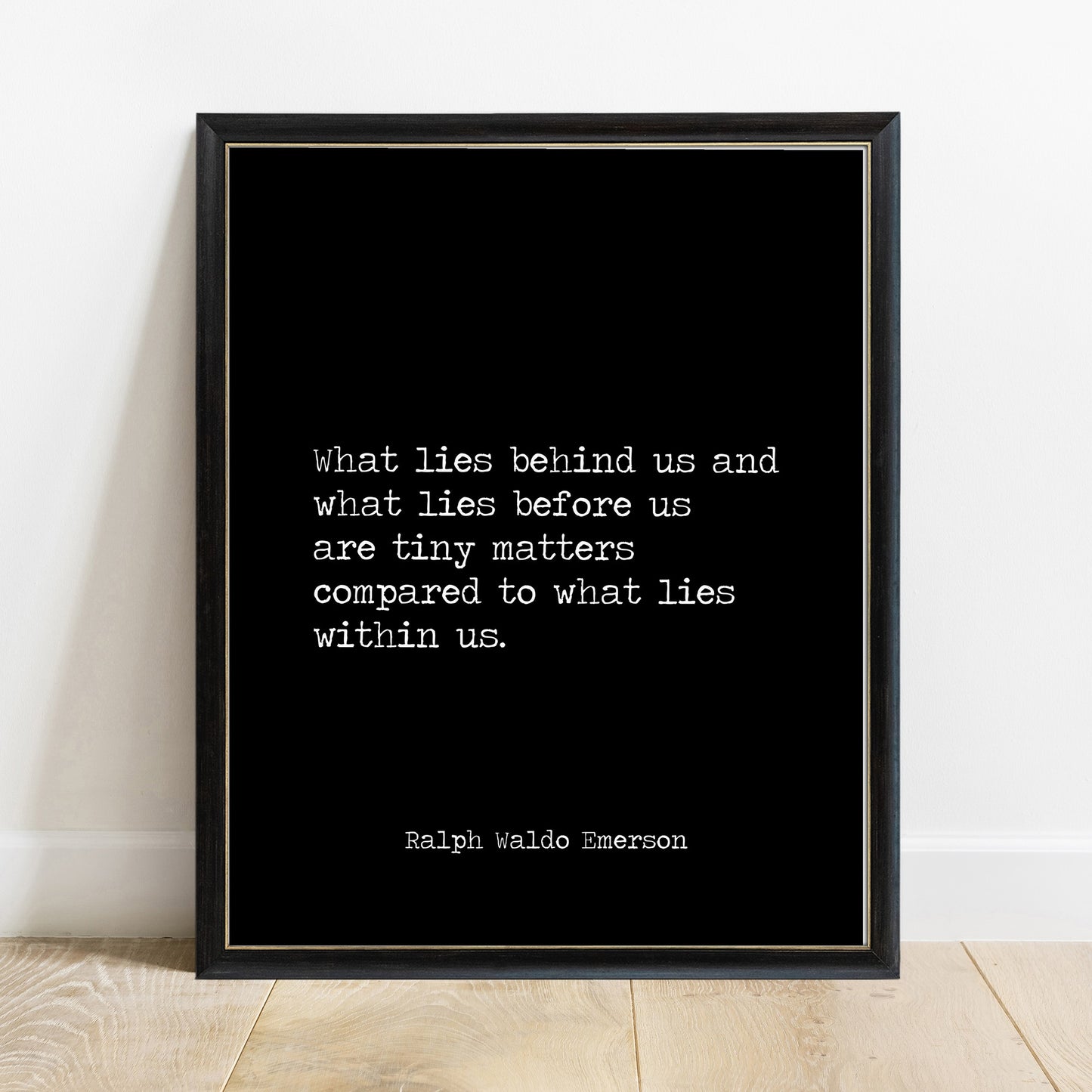 Ralph Waldo Emerson what lies within us print in a black frame, black background