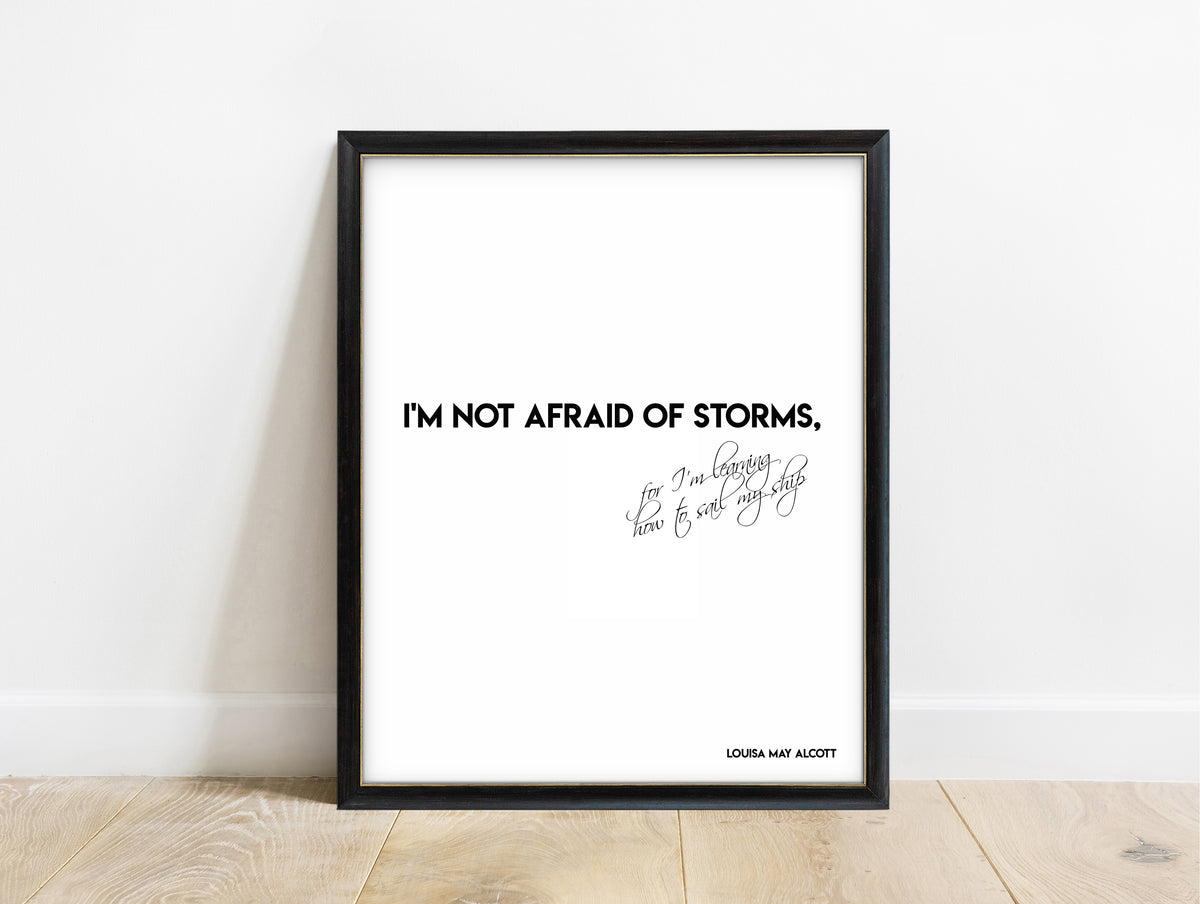Louisa May Alcott not afraid of storms bold script quote print in a black frame, white background