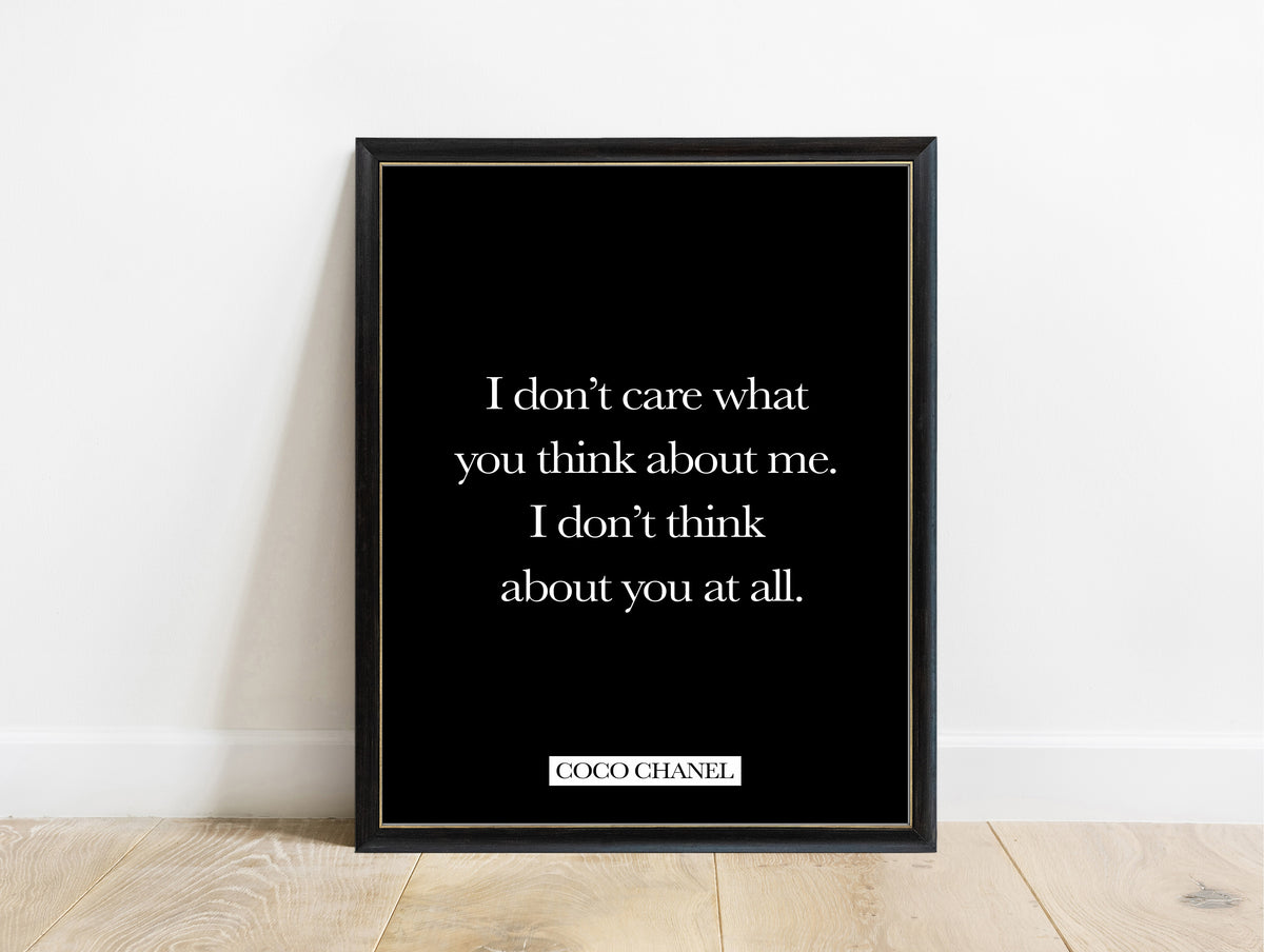 Coco Chanel I don't care what you think quote print in a black frame, black background