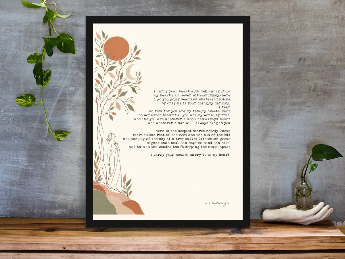 E. E. Cummings i carry your heart poem with tree and moon illustration print framed on a desk