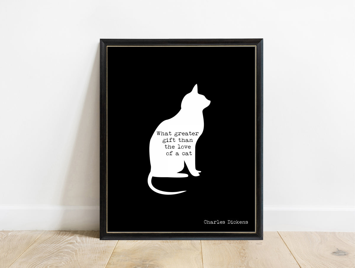 Charles Dickens love of a cat quote with a cat silhouette print in a black frame, black background