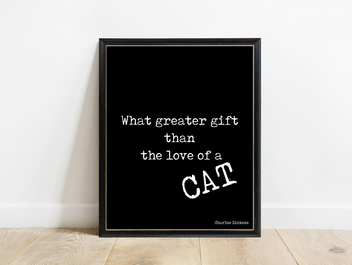 Charles Dickens love of a cat quote print in a black frame, black background