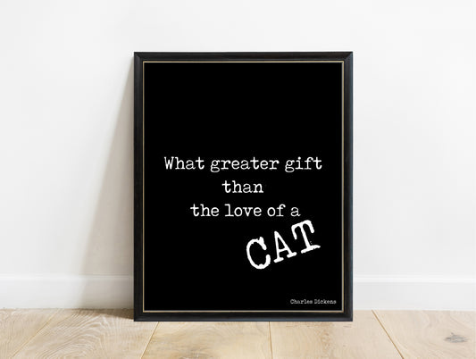 Charles Dickens love of a cat quote print in a black frame, black background