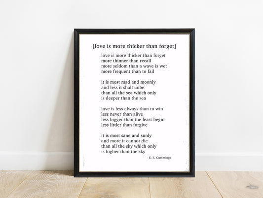 EE Cummings Love Is More Thicker Than Forget poem print in a black frame, white background