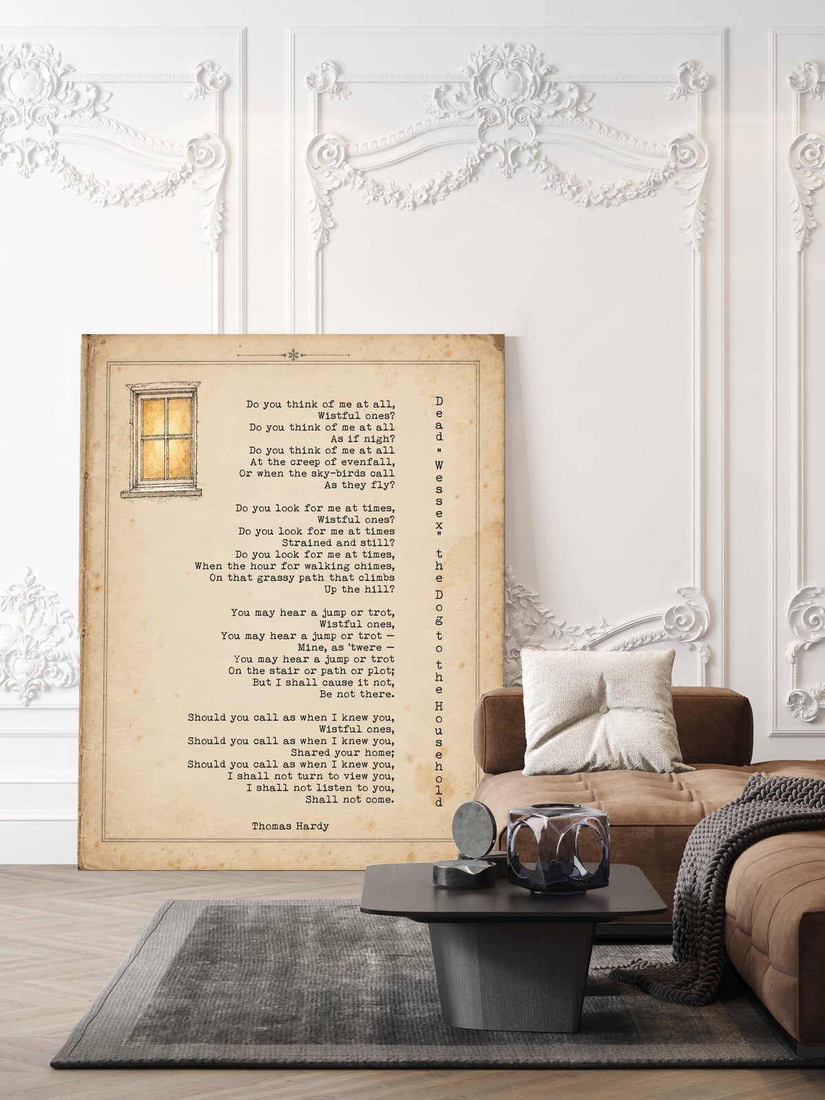 Thomas Hardy Dead Wessex the Dog to the Household poem print on a vintage page with a small lit window, shown unframed in a living room