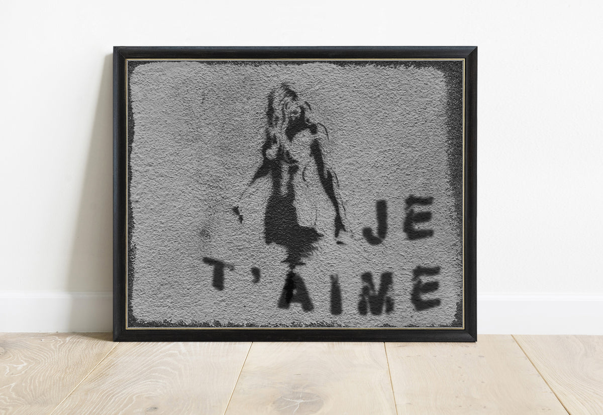 Je t'aime Paris street art photograph of a stencil girl on a grey wall, black and white, in a black frame