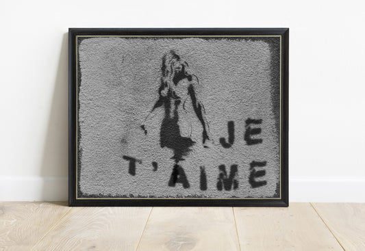 Je t'aime Paris street art photograph of a stencil girl on a grey wall, black and white, in a black frame