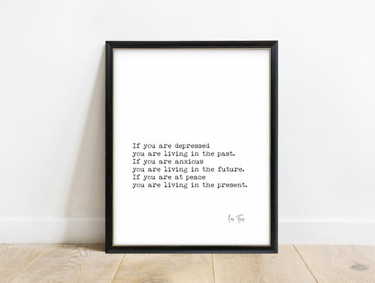 Lao Tzu living in the present typewriter quote print in a black frame, white background