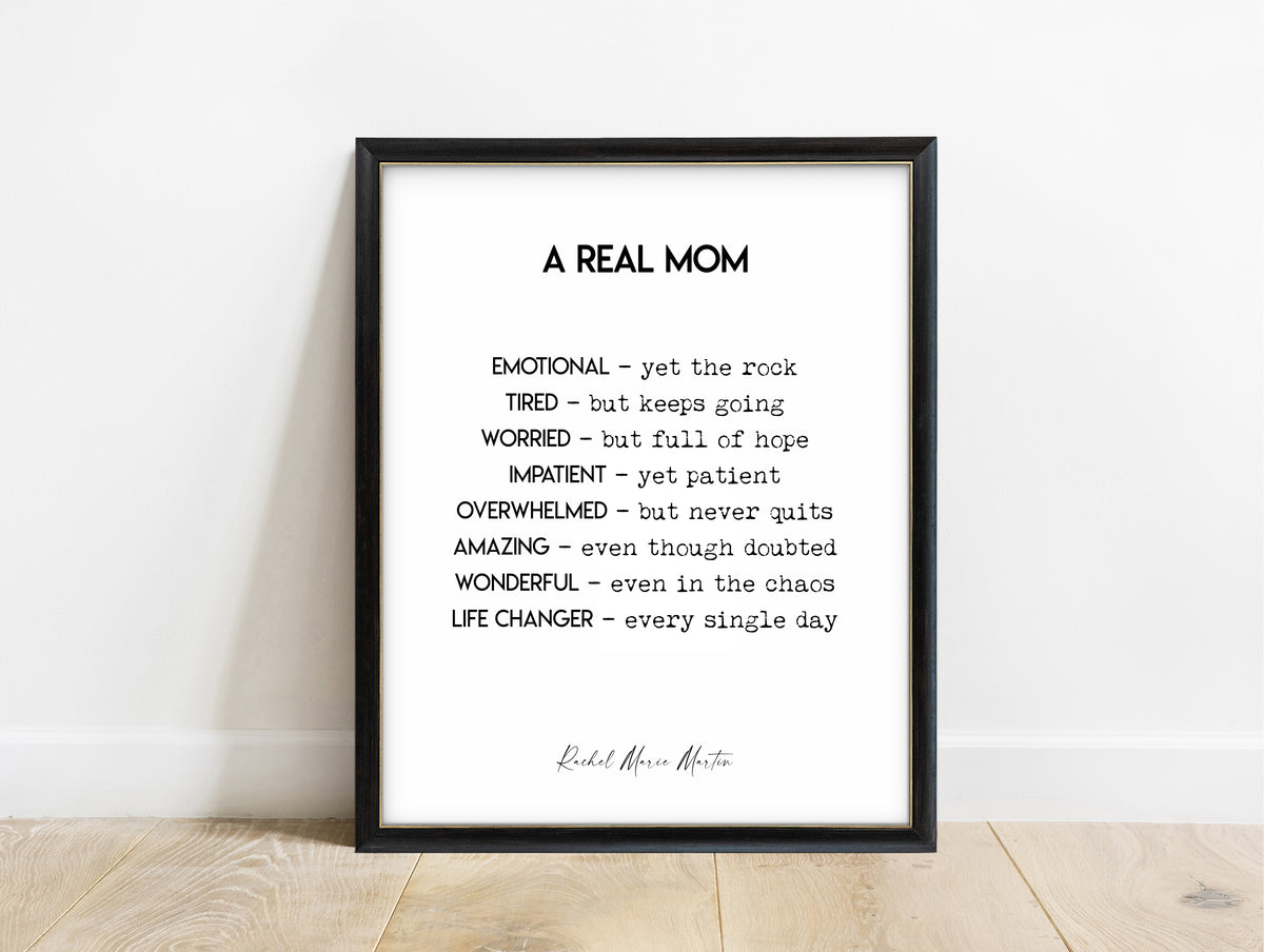 Rachel Marie Martin A Real Mom quote print in a black frame, white background