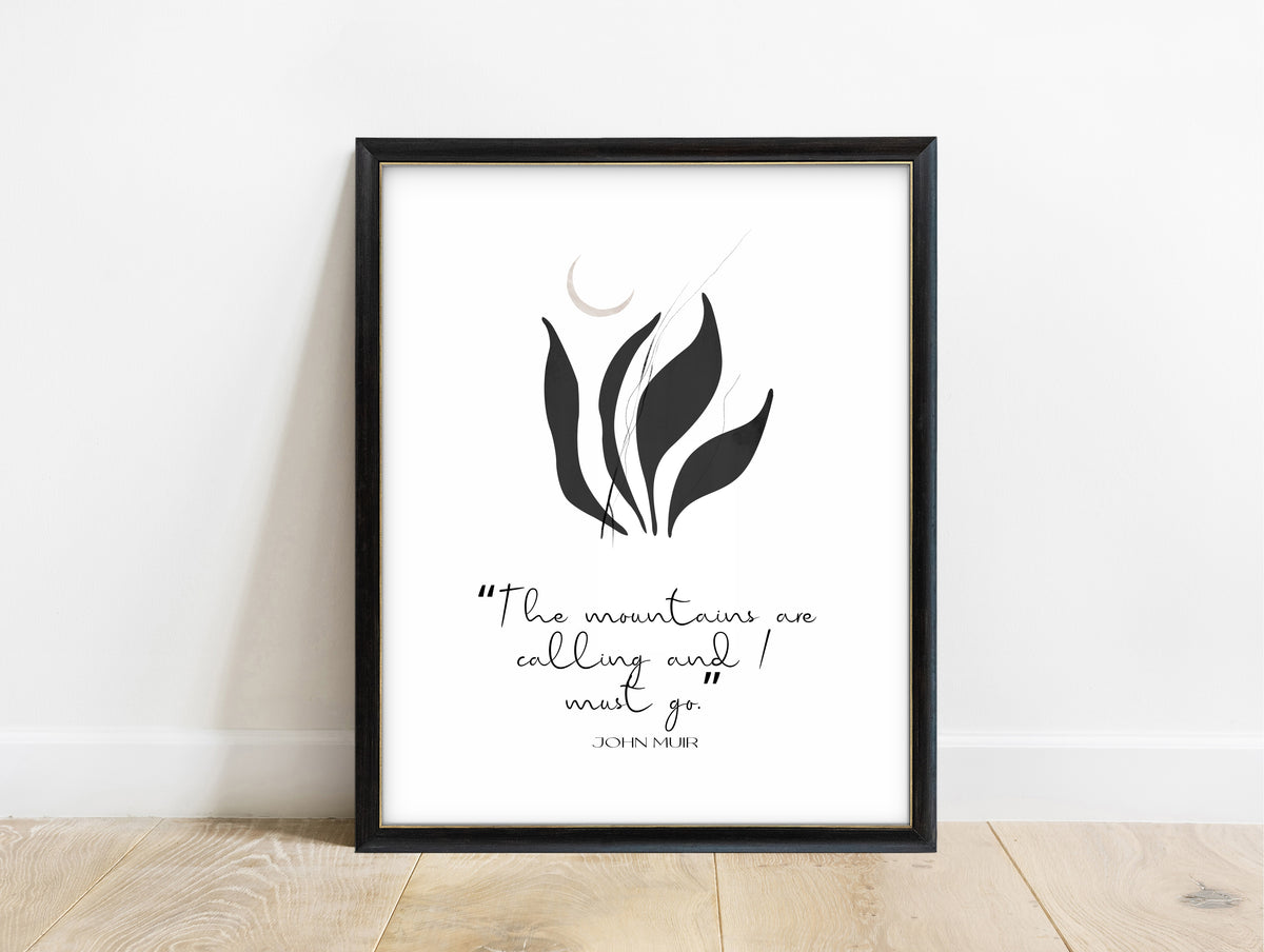John Muir the mountains are calling and I must go quote print with black botanical leaves, in a black frame
