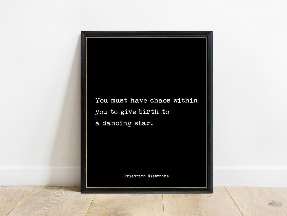 Friedrich Nietzsche chaos within you to give birth to a dancing star typewriter quote print in a black frame, black background