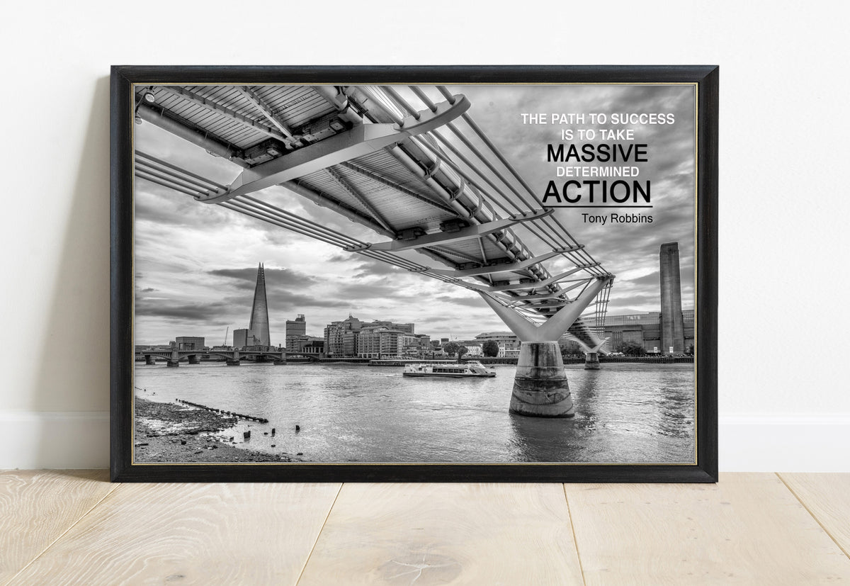 Tony Robbins massive determined action quote over a black and white photograph of the Millennium Bridge, London, in a black frame