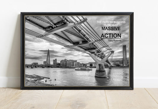 Tony Robbins massive determined action quote over a black and white photograph of the Millennium Bridge, London, in a black frame