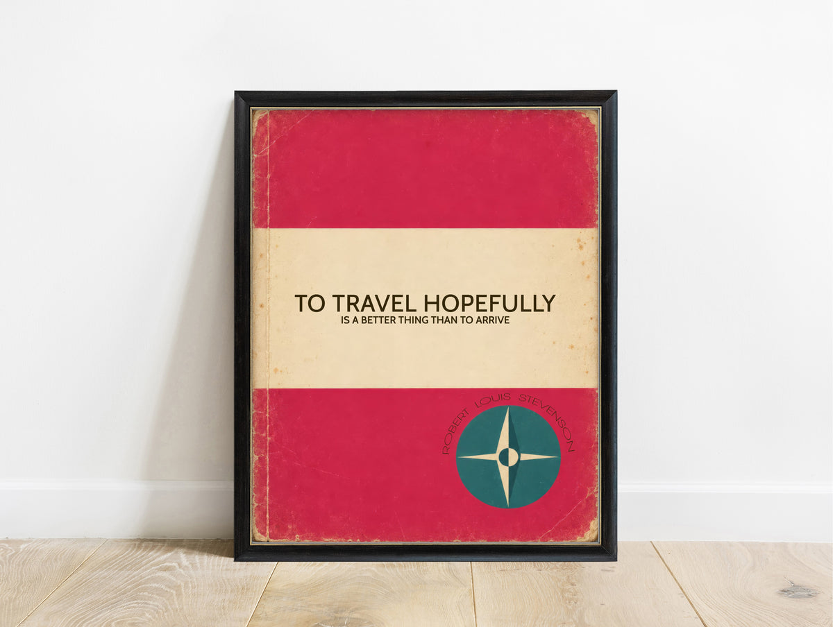 To travel hopefully is a better thing than to arrive, Robert Louis Stevenson quote in a retro pink book cover design with a compass, in a black frame