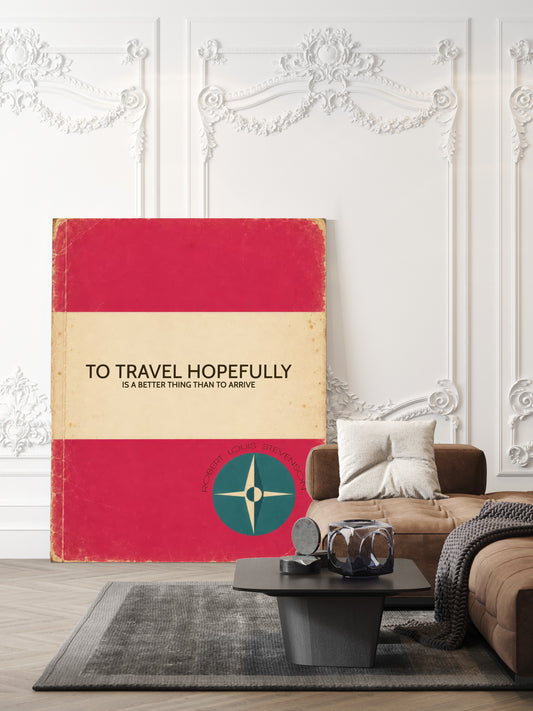 To travel hopefully is a better thing than to arrive, Robert Louis Stevenson quote in a retro pink book cover design with a compass, shown unframed in a living room