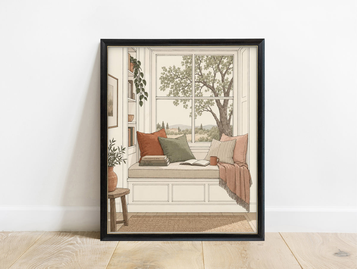Window seat reading nook with books and a tree view illustration print in a black frame