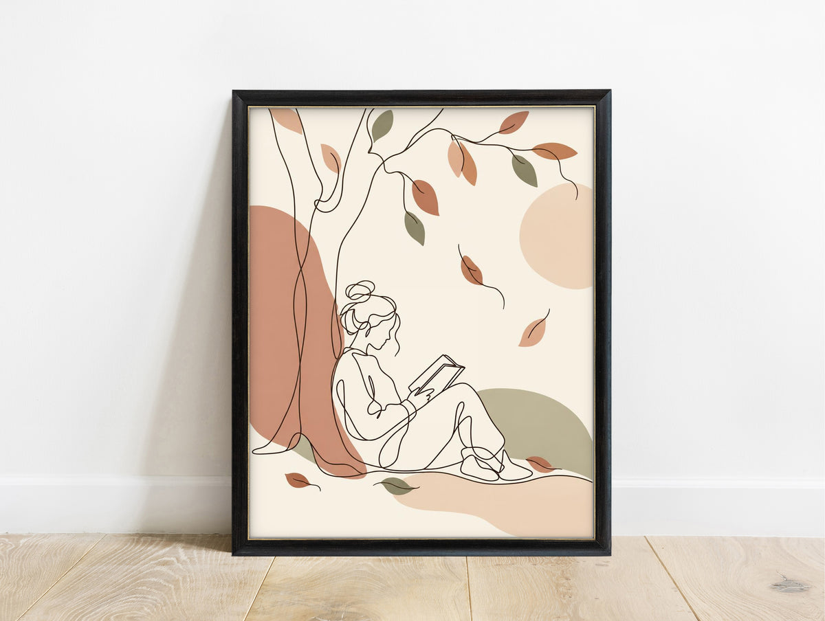 Line art of a woman reading under a tree with falling autumn leaves in boho colours in a black frame