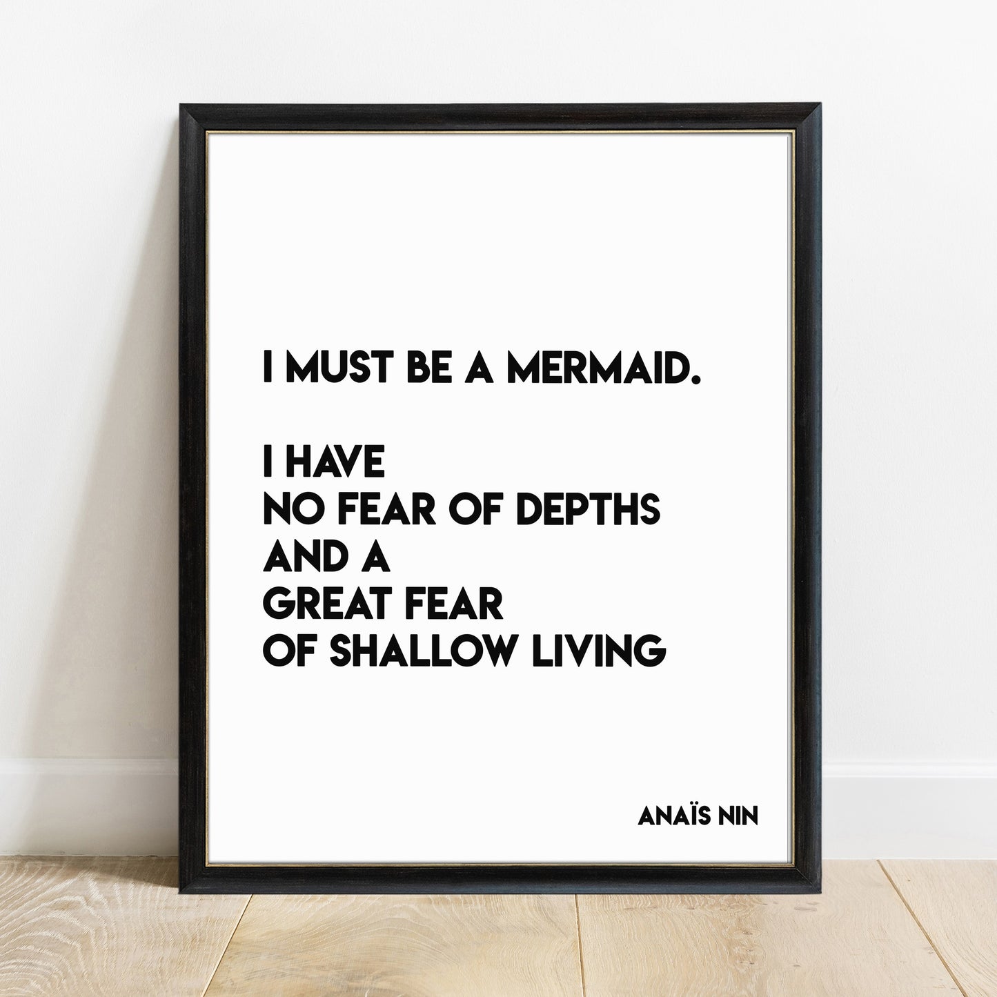 Anais Nin I must be a mermaid quote print in a black frame, white background