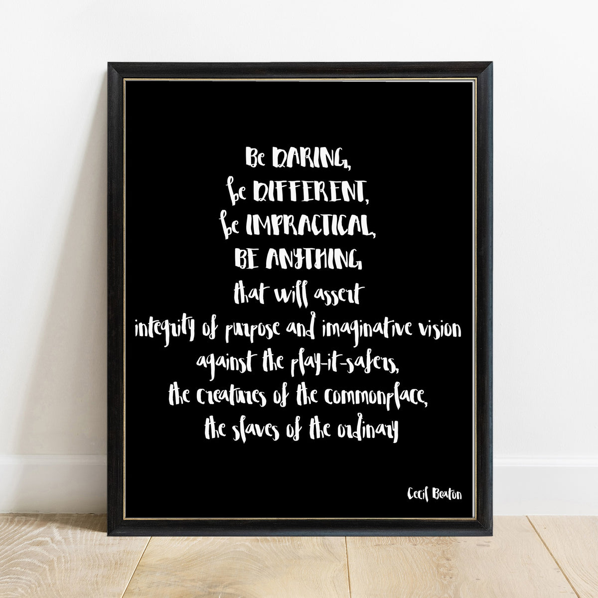 Cecil Beaton be daring be different quote print in a black frame, black background