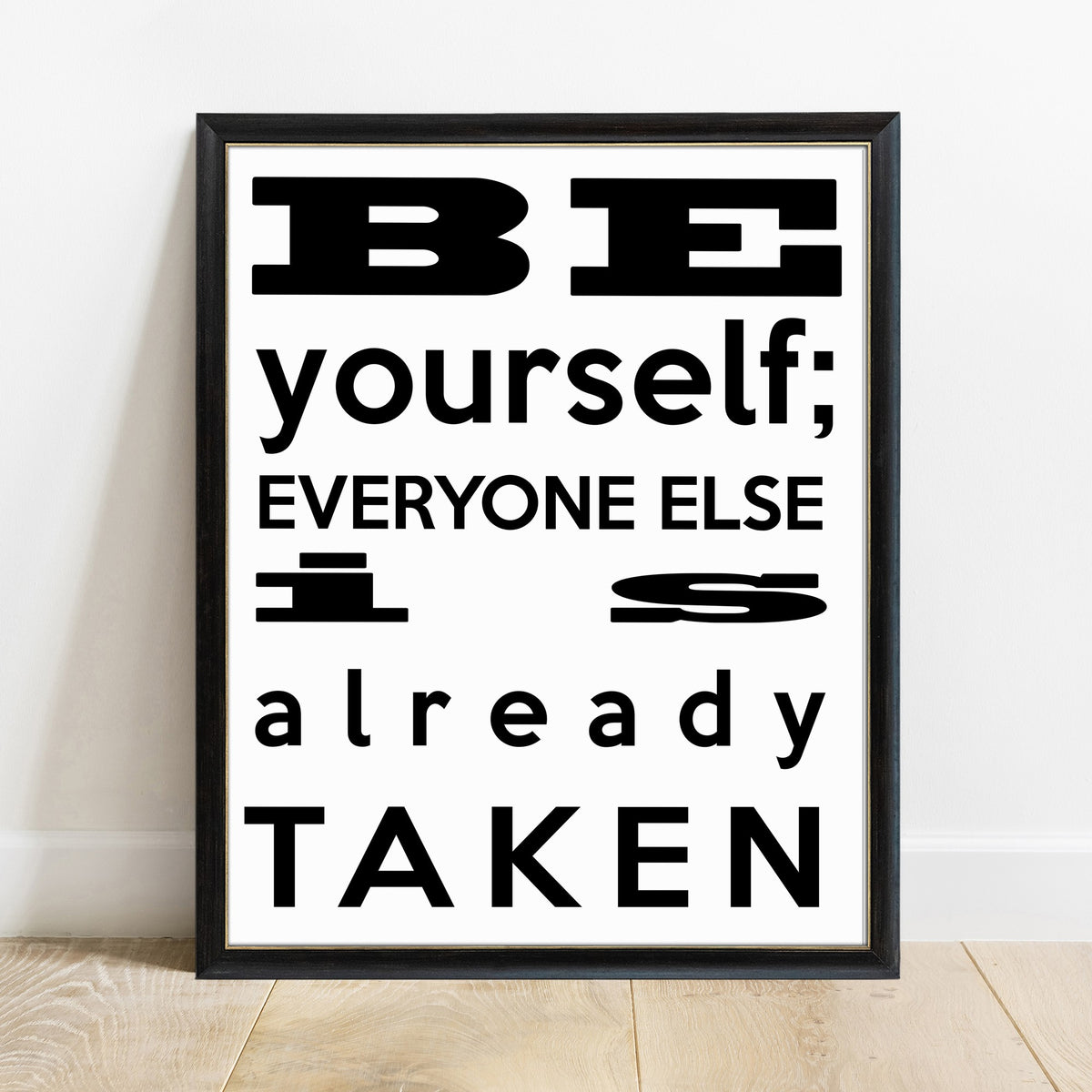 Oscar Wilde be yourself everyone else is already taken modern quote print in a black frame, black background