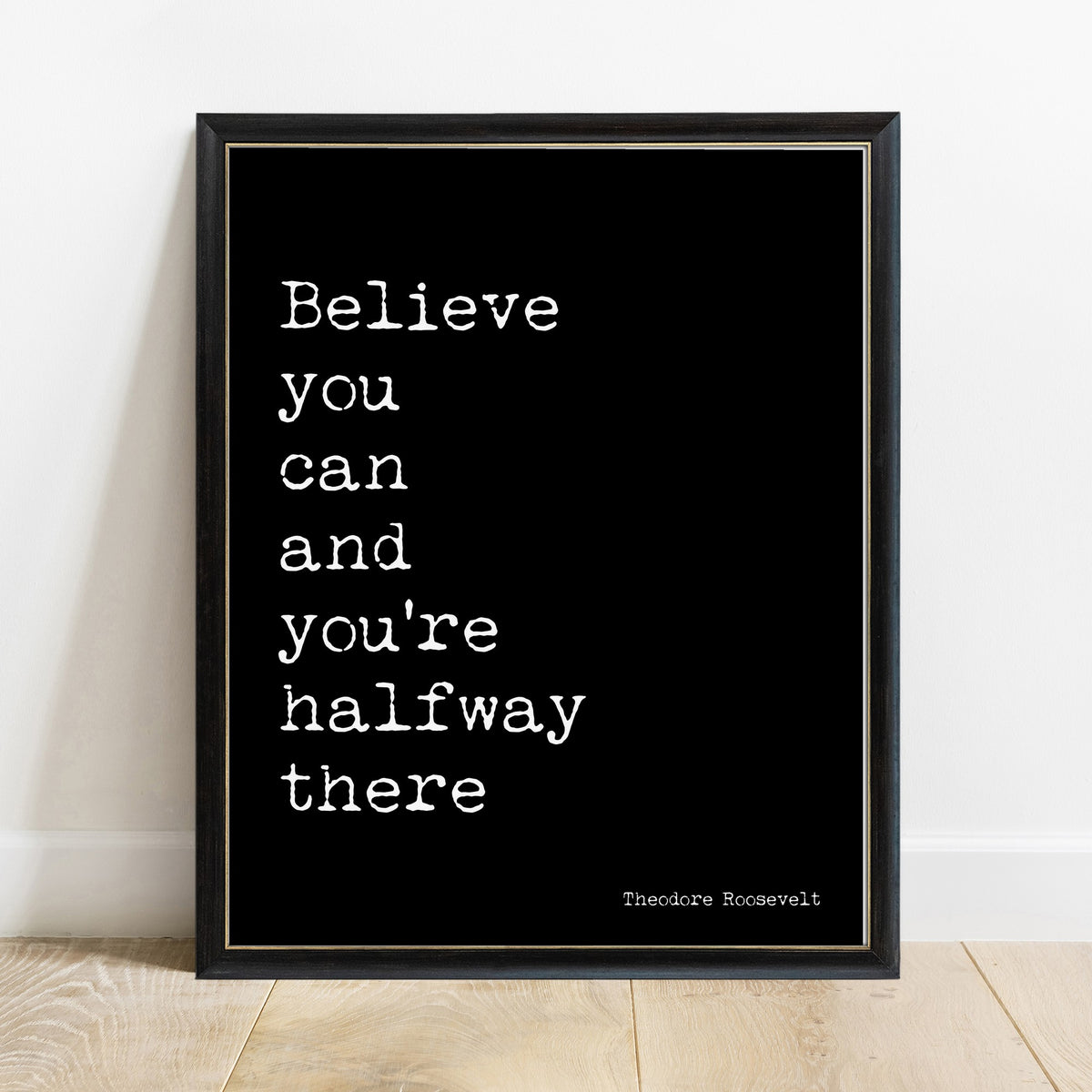 Theodore Roosevelt believe you can and you're halfway there quote print in a black frame, black background