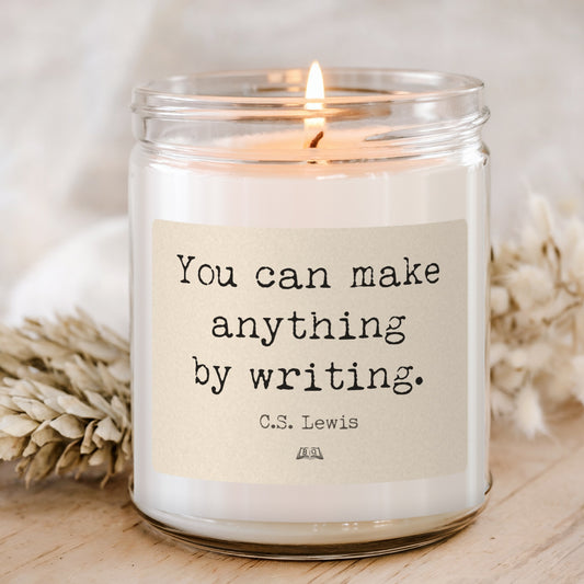 Lit soy candle in a glass jar with the C.S. Lewis You can make anything by writing label