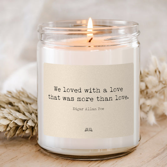 Lit soy candle in a glass jar with the Edgar Allan Poe We loved with a love label