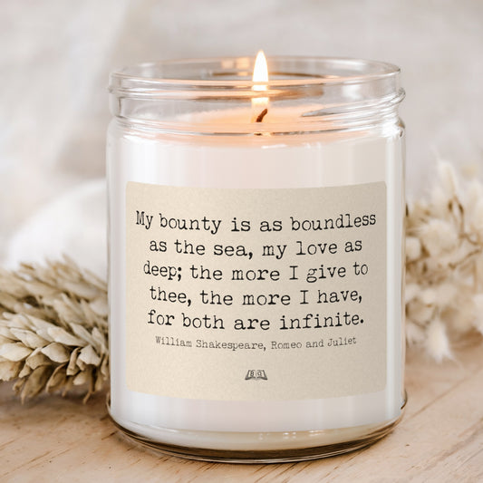 Lit soy candle in a glass jar with the Shakespeare Romeo and Juliet My bounty is as boundless as the sea label