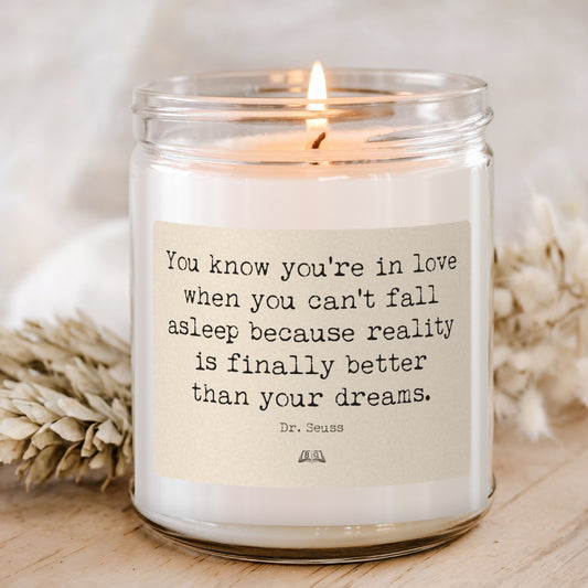 Lit soy candle in a glass jar with the Dr. Seuss You know you're in love when you can't fall asleep label