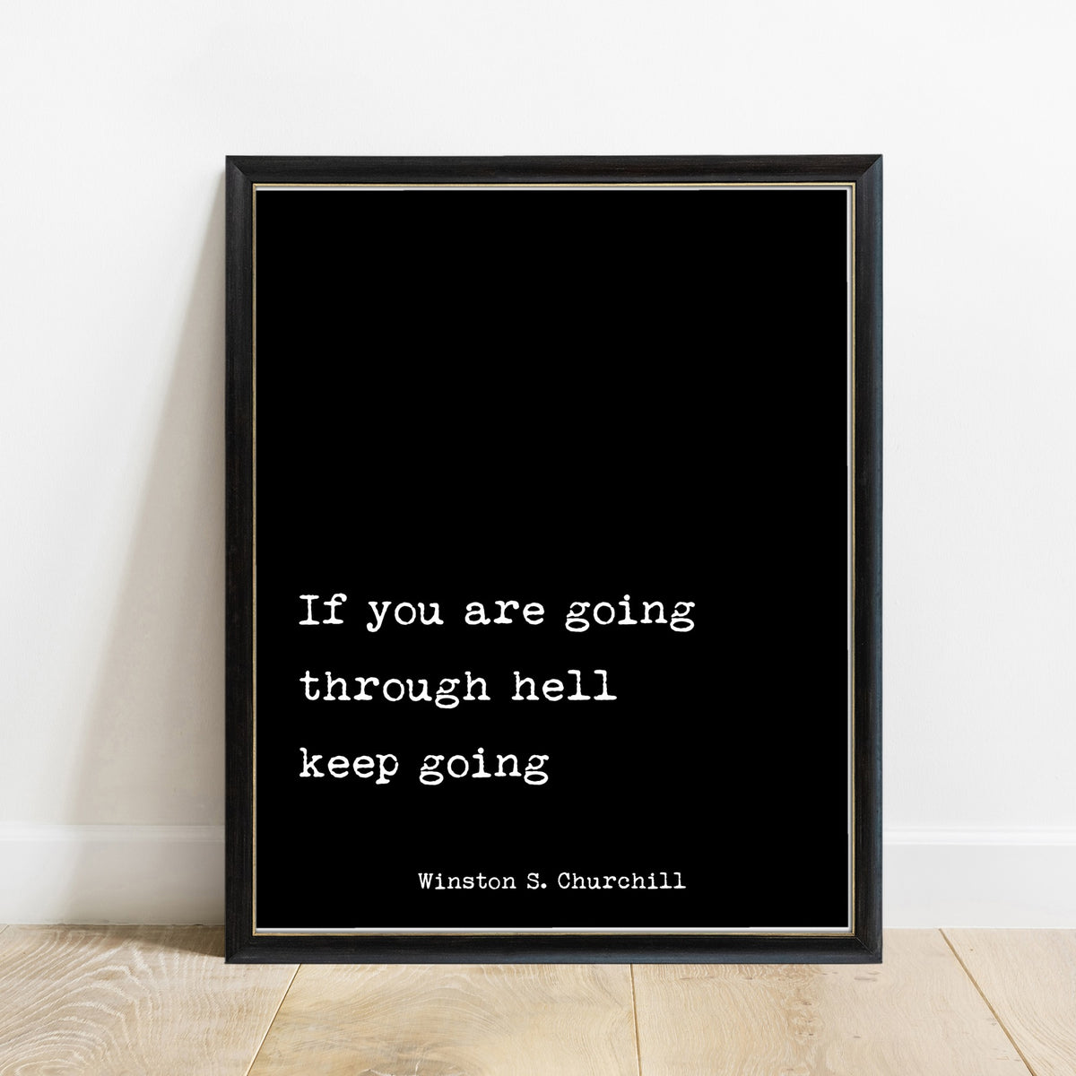 Winston Churchill If You Are Going Through Hell print in a black frame, black background