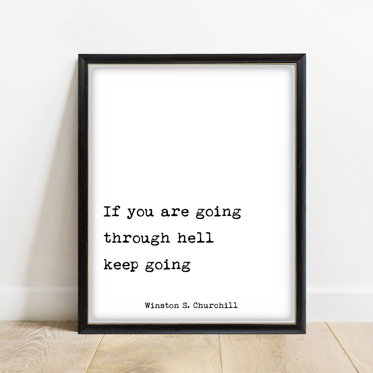 Winston Churchill If You Are Going Through Hell print in a black frame, white background