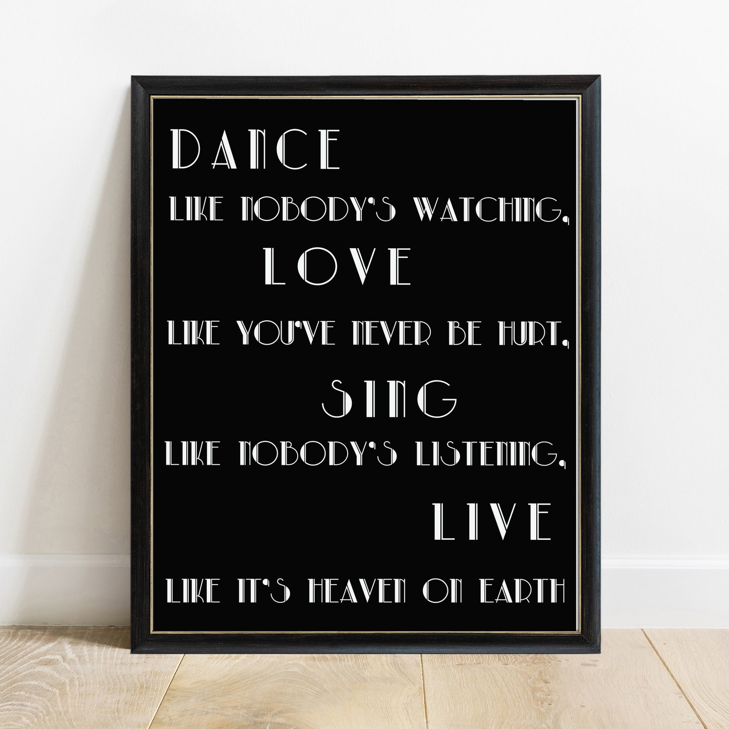 Dance like nobody's watching Alfred D'Souza quote print in a black frame, black background