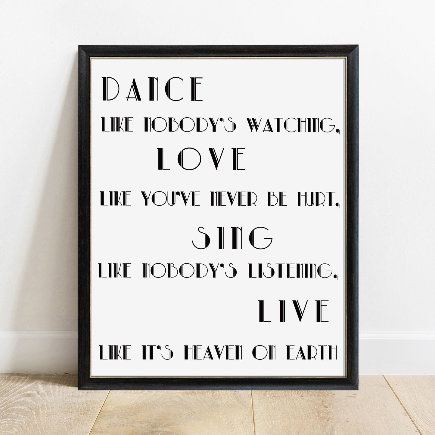 Dance like nobody's watching Alfred D'Souza quote print in a black frame, white background