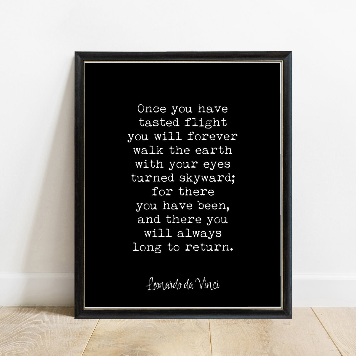Leonardo da Vinci once you have tasted flight quote print in a black frame, black background