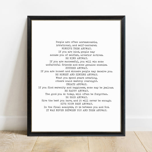 Do It Anyway Mother Teresa poem print in a black frame, white background