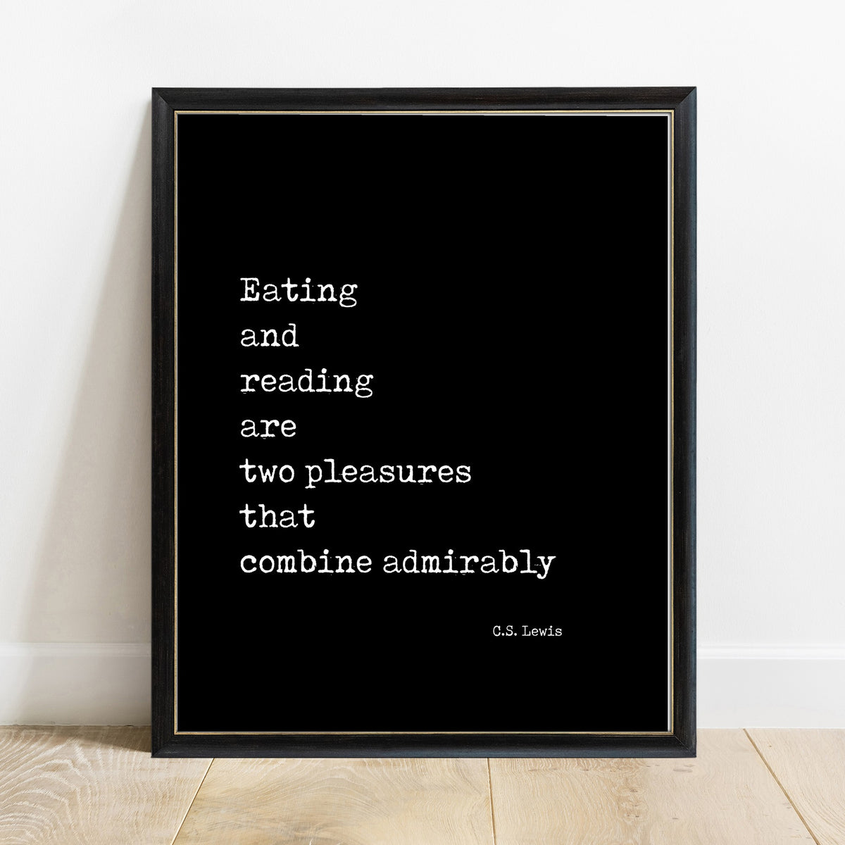C.S. Lewis eating and reading quote print in a black frame, black background