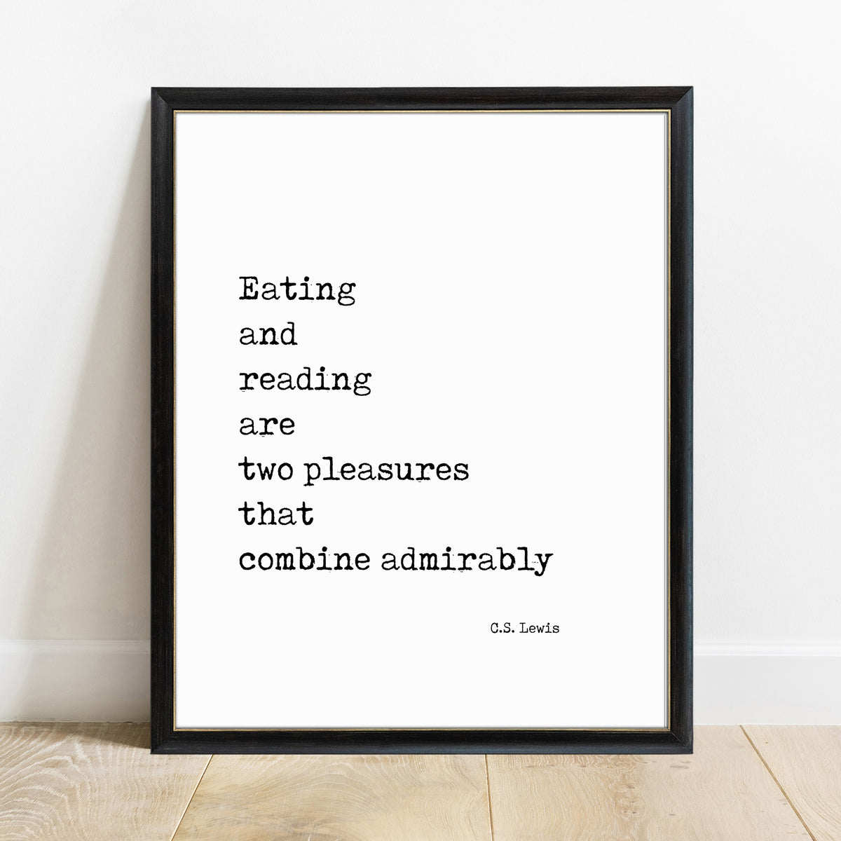 C.S. Lewis eating and reading quote print in a black frame, white background