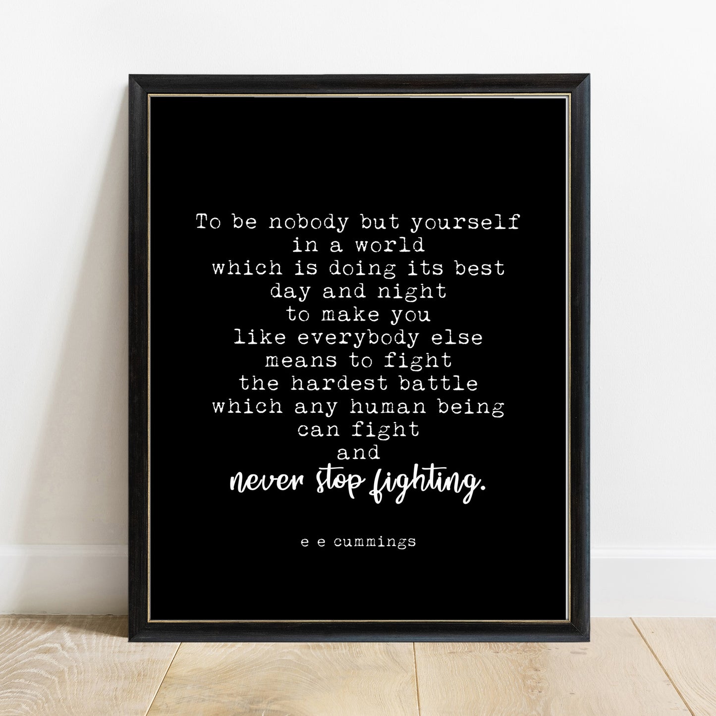EE Cummings to be nobody but yourself quote print in a black frame, black background