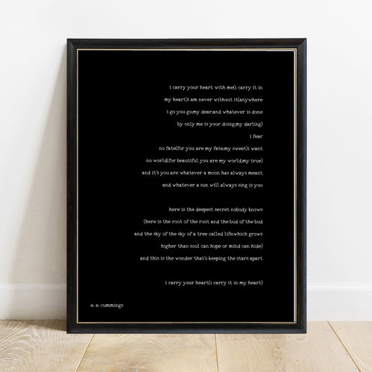 EE Cummings i carry your heart full poem print in a black frame, black background