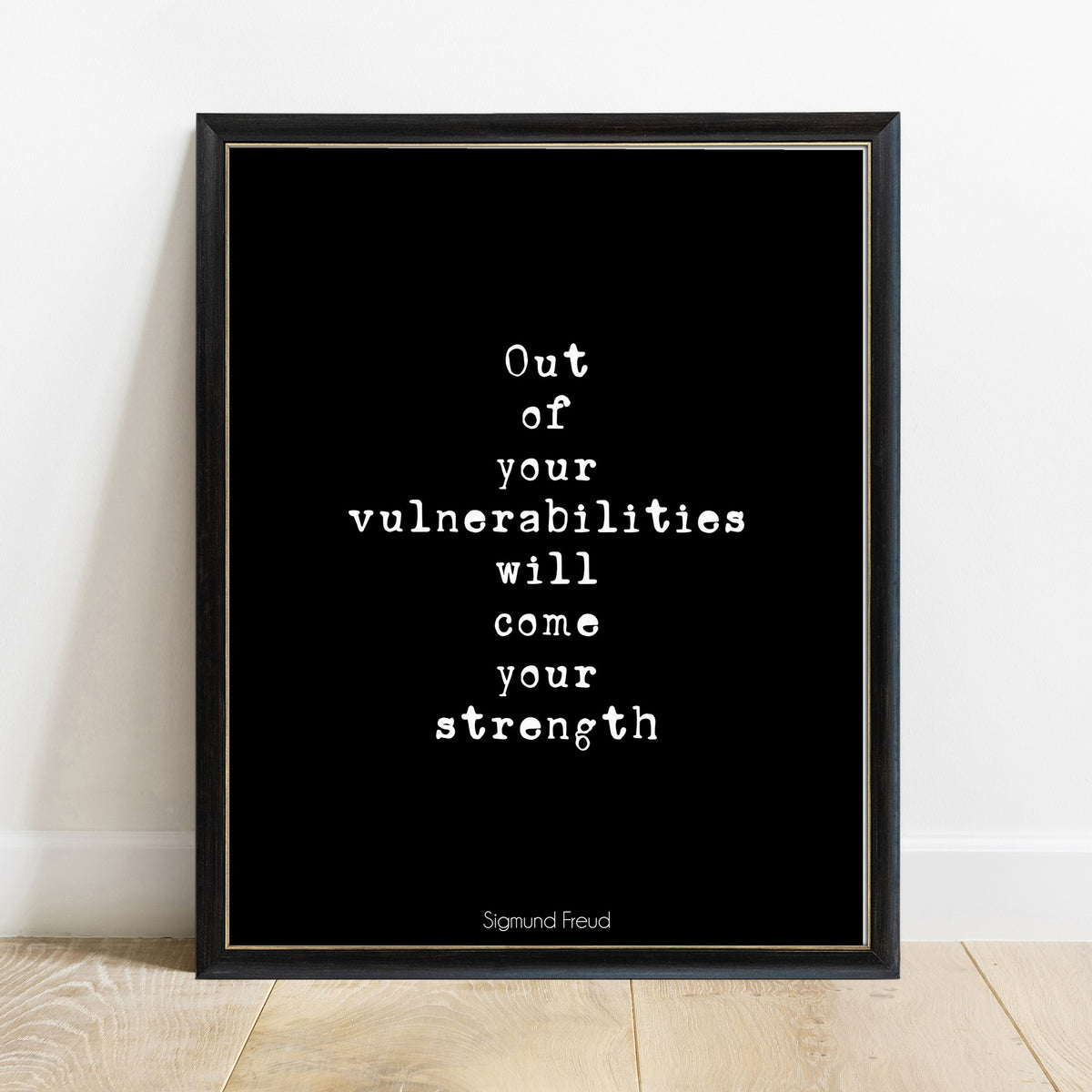 Sigmund Freud out of your vulnerabilities will come your strength typewriter quote print in a black frame, black background
